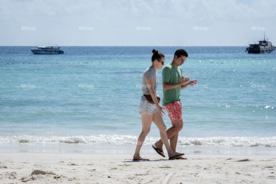 Young couple walk on the beautiful beach together