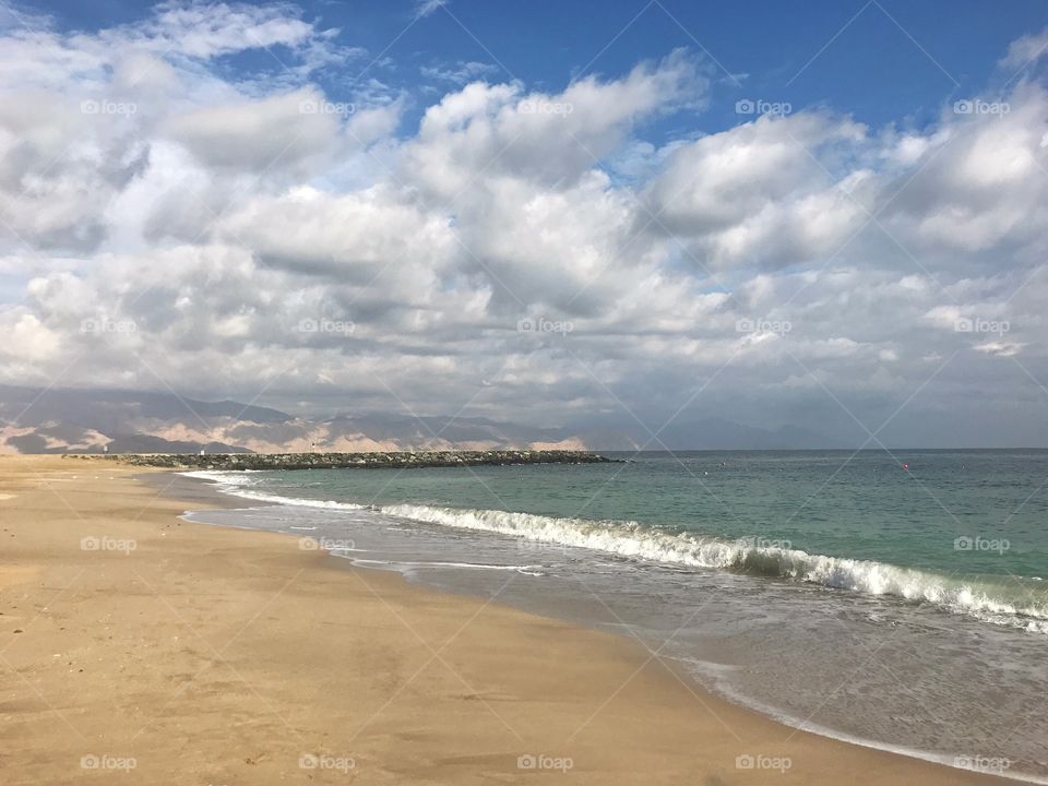 Deserted beach during a cloudy day