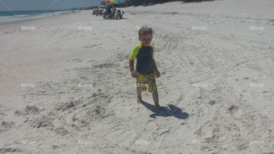 young boy having fun on beach