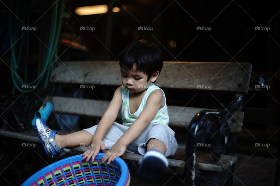 A boy playing with clothes basket