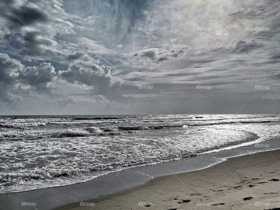 Sea waves in the windy day with stormy sky.