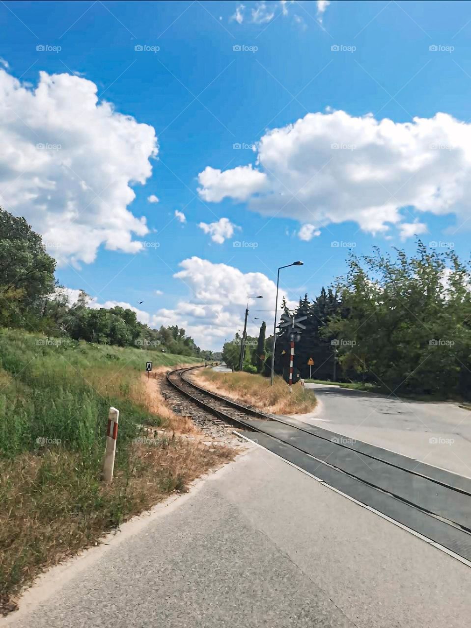 "Country Railroad Crossing with Blue Skies"
