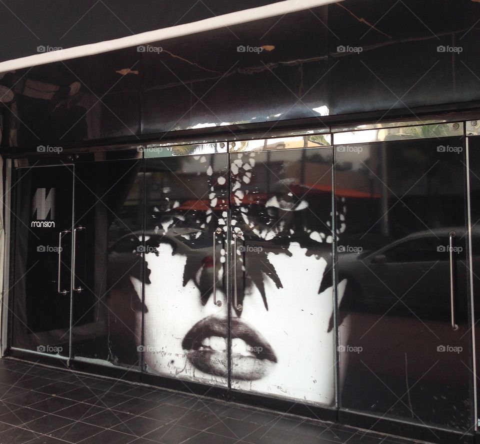 Masked woman window display. Miami black & white masked woman photo window display