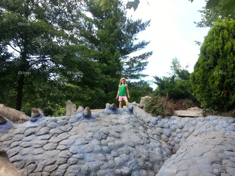 Queen of the Dragons. My daughter on top of the giant dragon sculpture at castle park. 
