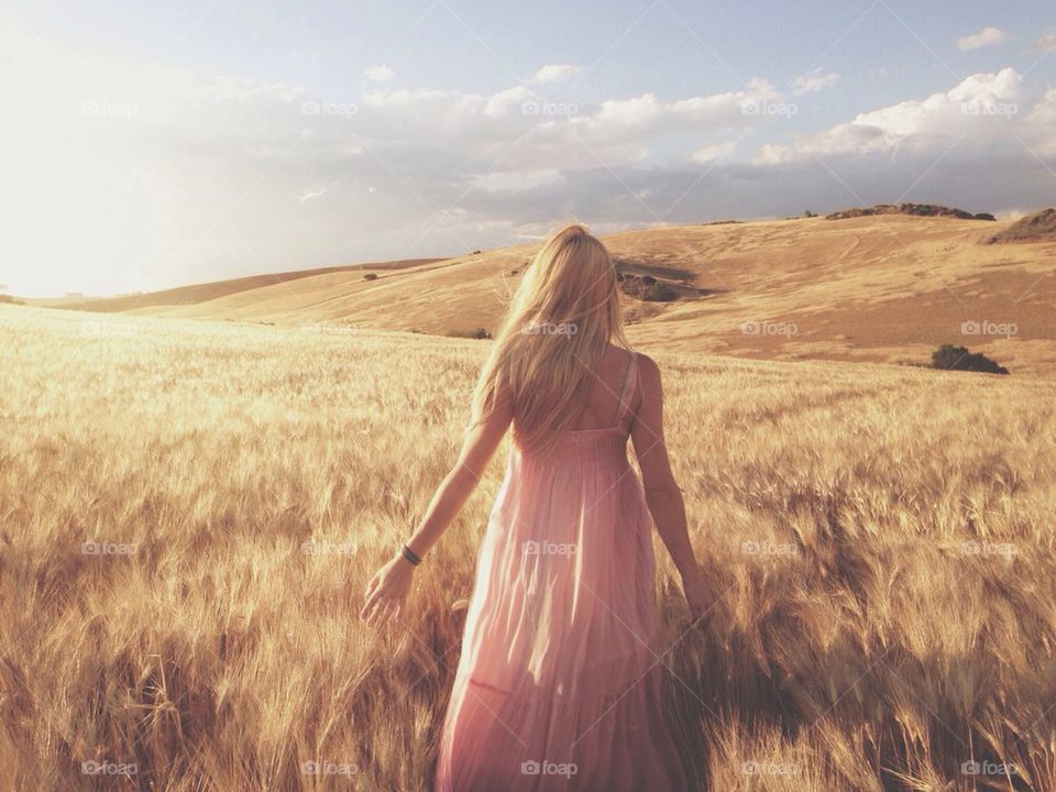 Rear view of a woman standing in field