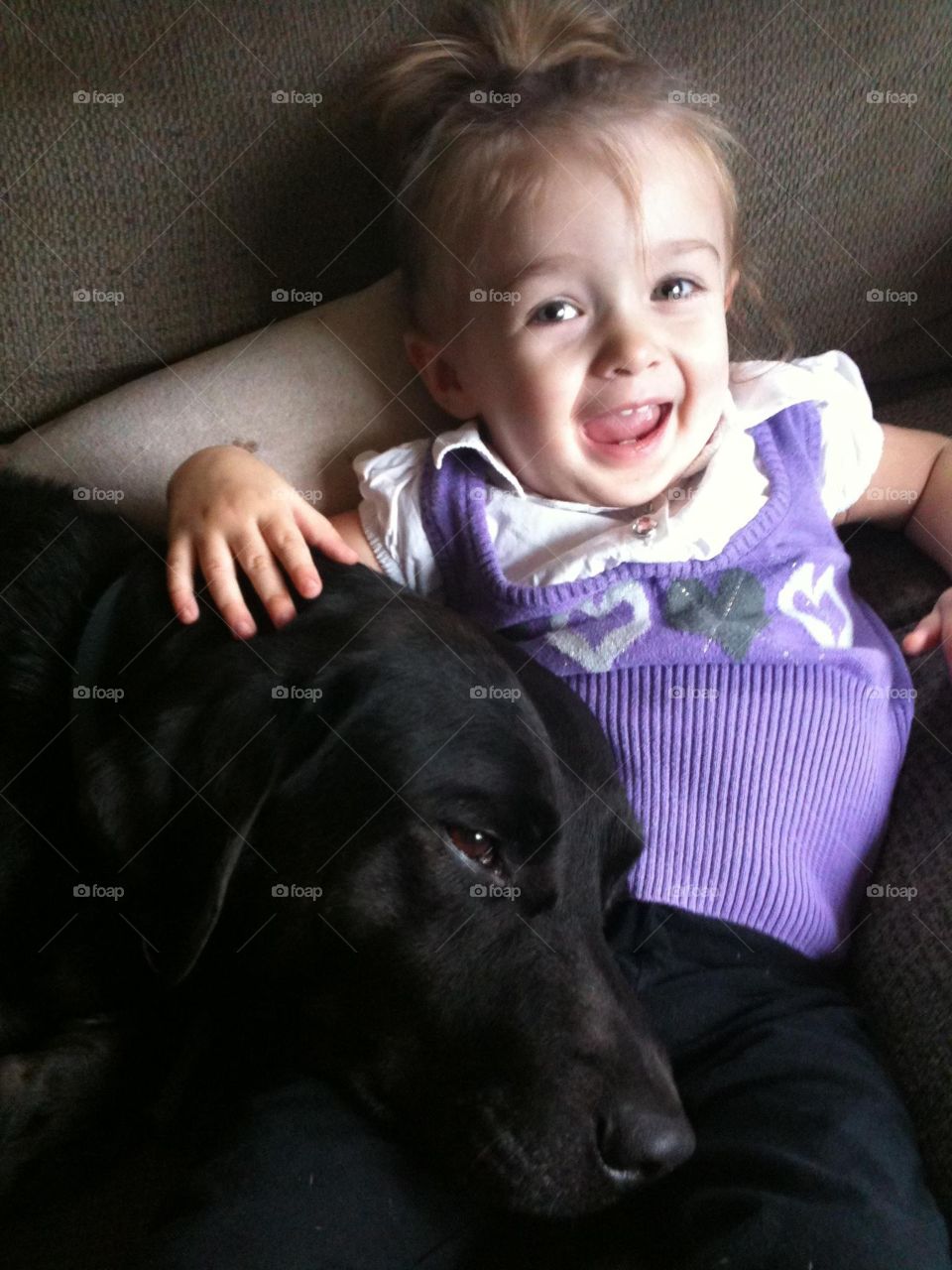 Logan & Bean. My daughter, as a toddler snuggling with our lab, Logan. 