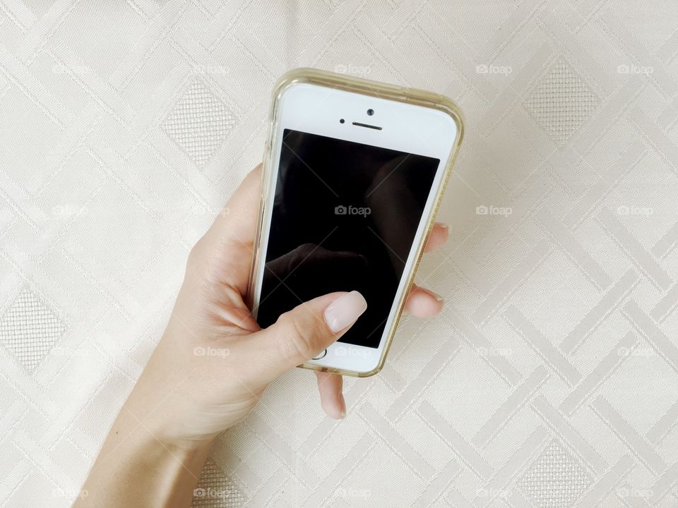 Woman's hand holding an iPhone 