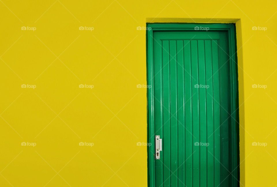 Photo of a yellow house with green door
