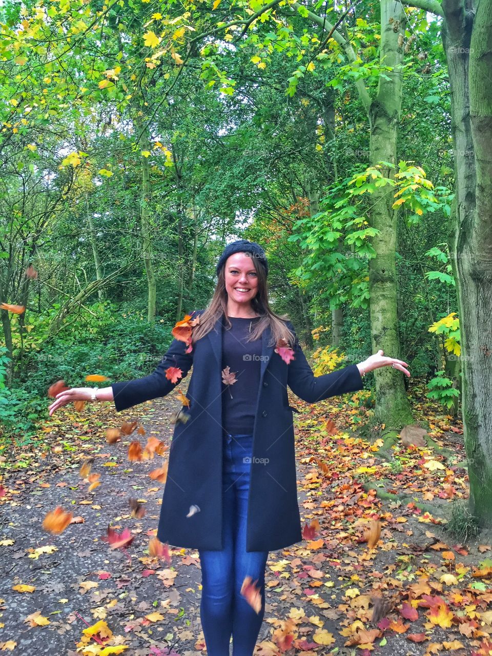 Beautiful young woman standing in autumn