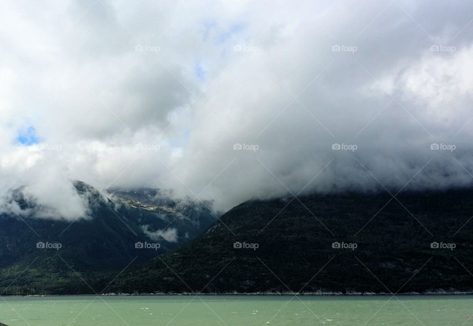Glacier Bay National Park 
Rock mountains cober with clouds
Alaska