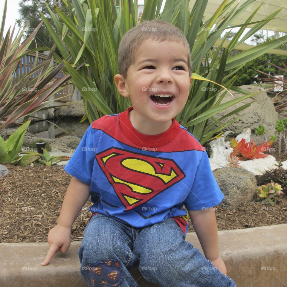 Smiling boy sitting in park