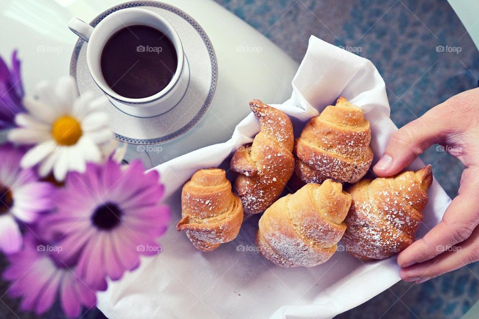 breakfast with pink flower, coffee and homemade croissant