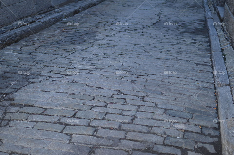 Worn down old cobblestone road in historic district 