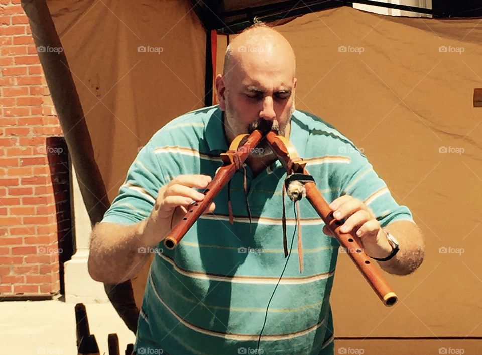 Man Playing Two Flutes 