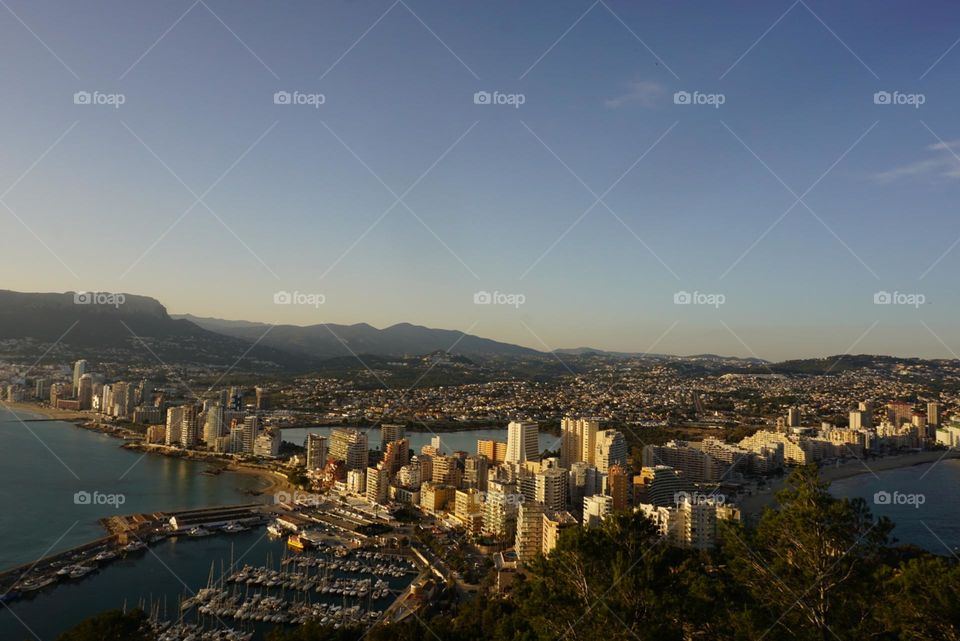 City#view#port#sea#buildings#boats#mountains