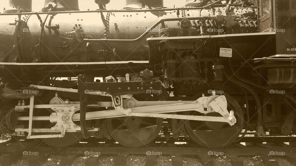 Vintage steam engine now retired in a history park. pictured in sepia