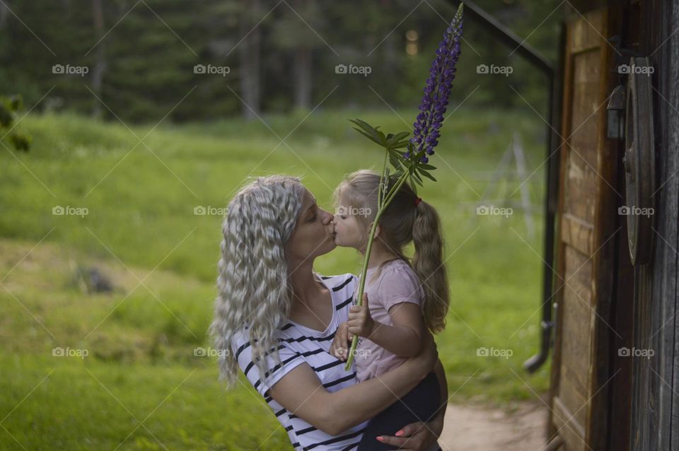 daughter giving a kiss to mother