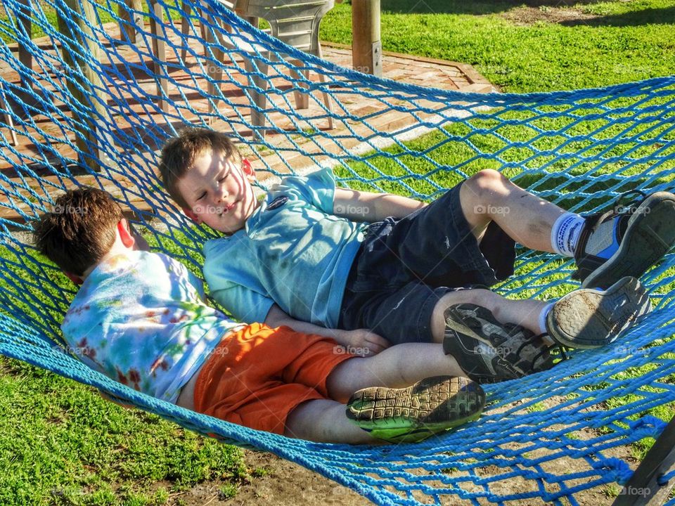 Young Brothers Playing In A Hammock