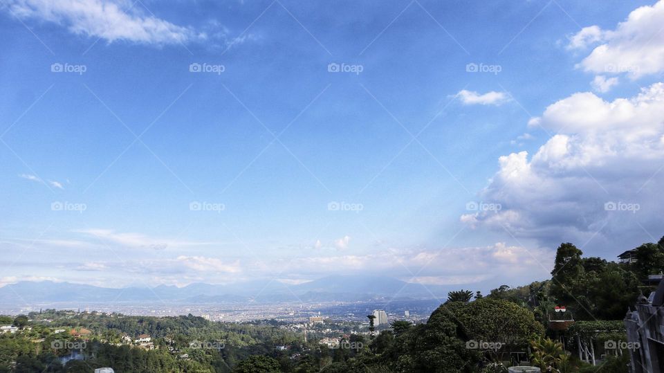 opical mountains and residential residential areas with blue skies.