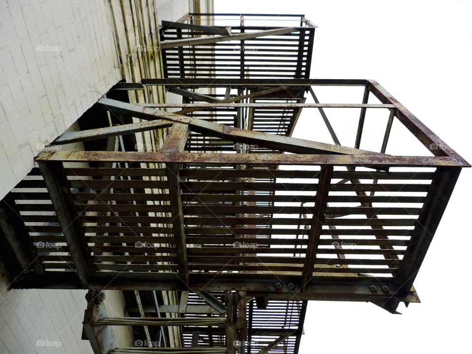 Escape by stairs. A fire escape of stairs outside an old building