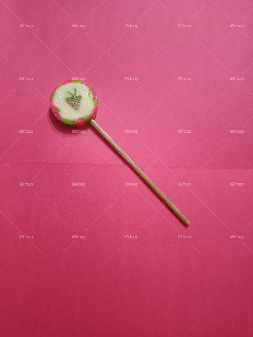 A handmade lollipop 🍭🍭🍭 on a magenta background