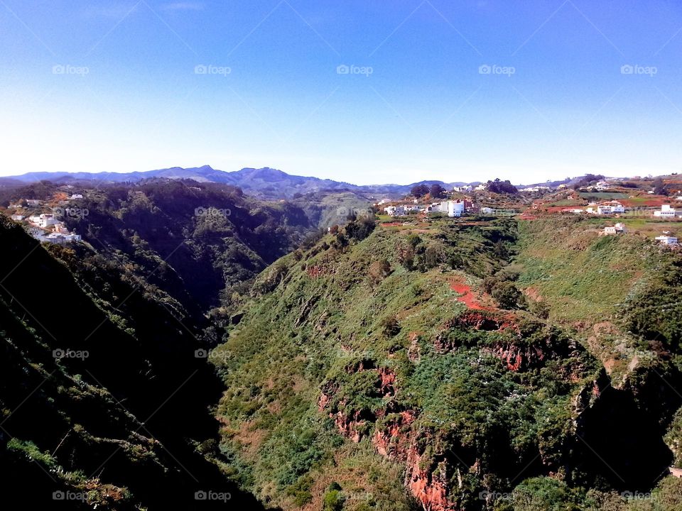 Deep green valley and white buildings