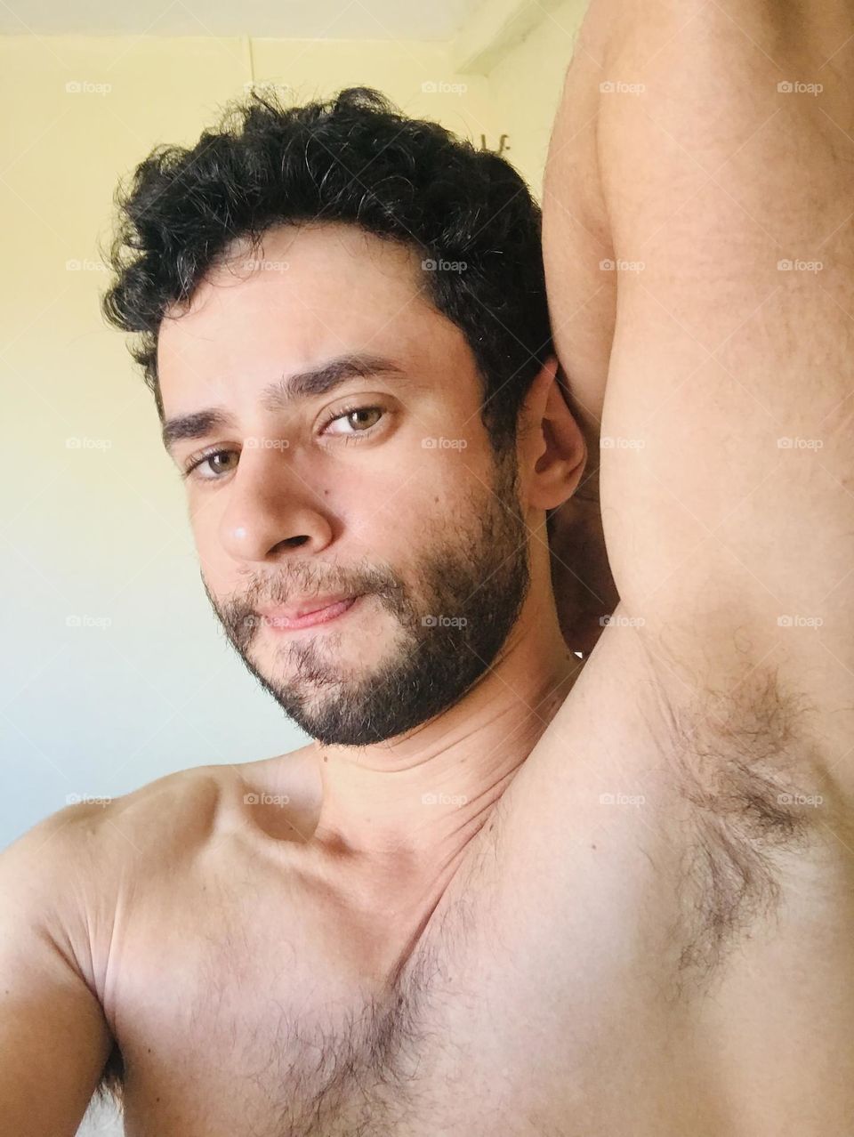 handsome man with beard showing his arm