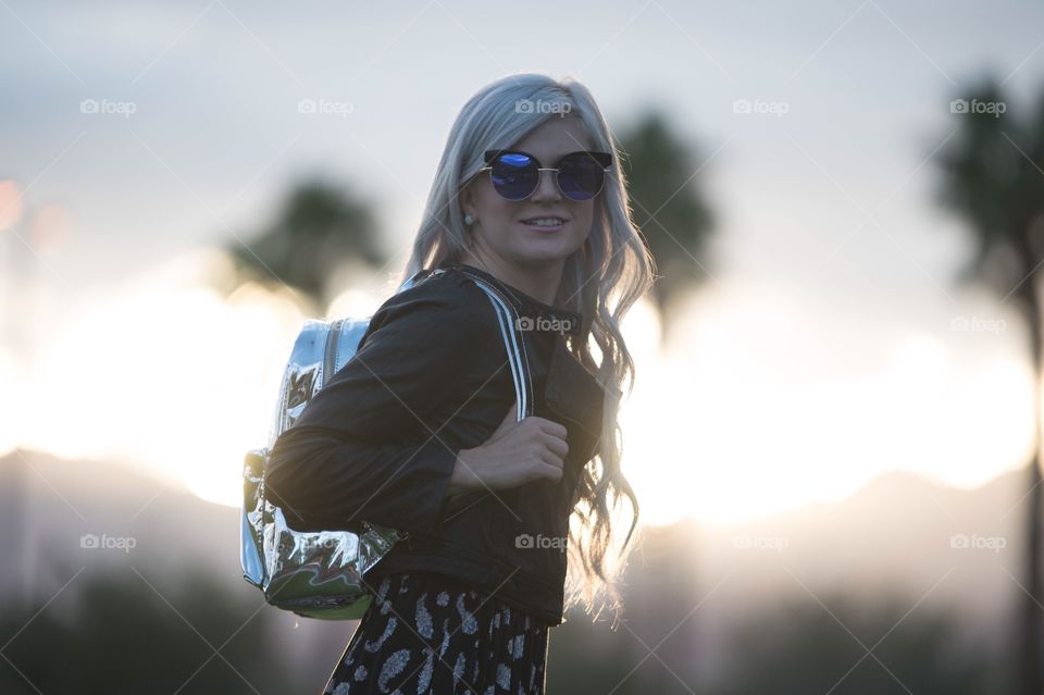 Outdoor girl backpack sunset glasses