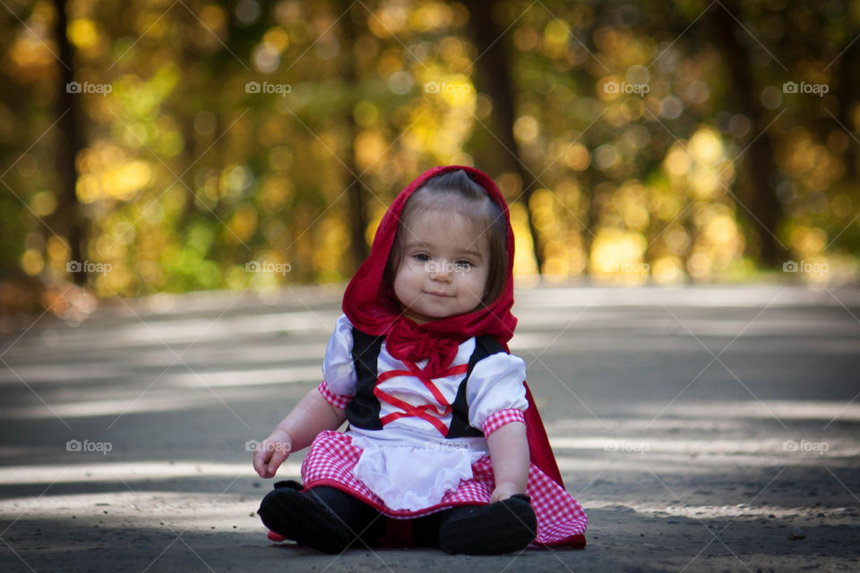 Little girl sitting on street