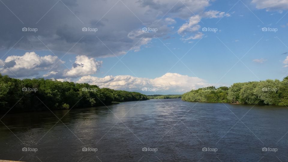 cloud as a duck wearing sunglasses over the river