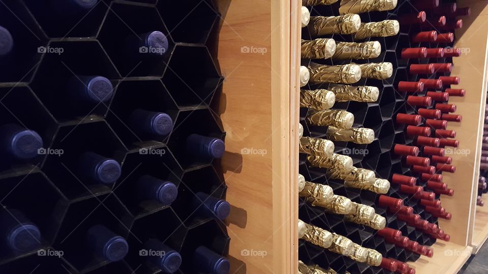 Wine bottles grouped by type waiting for purchase at a winery.