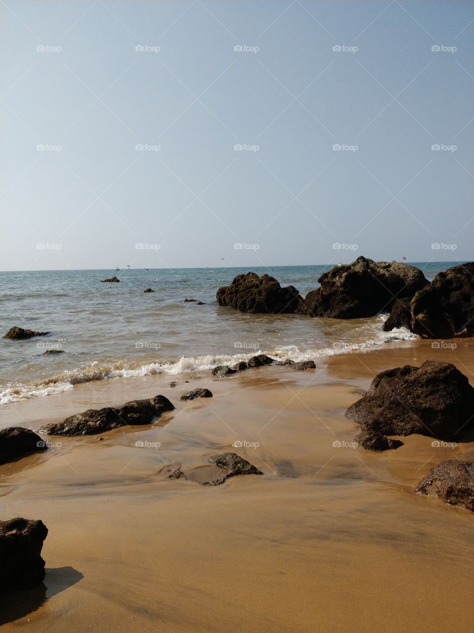 sea shore with rocks around. nature, beauty, sand, beach, sea, waves, water