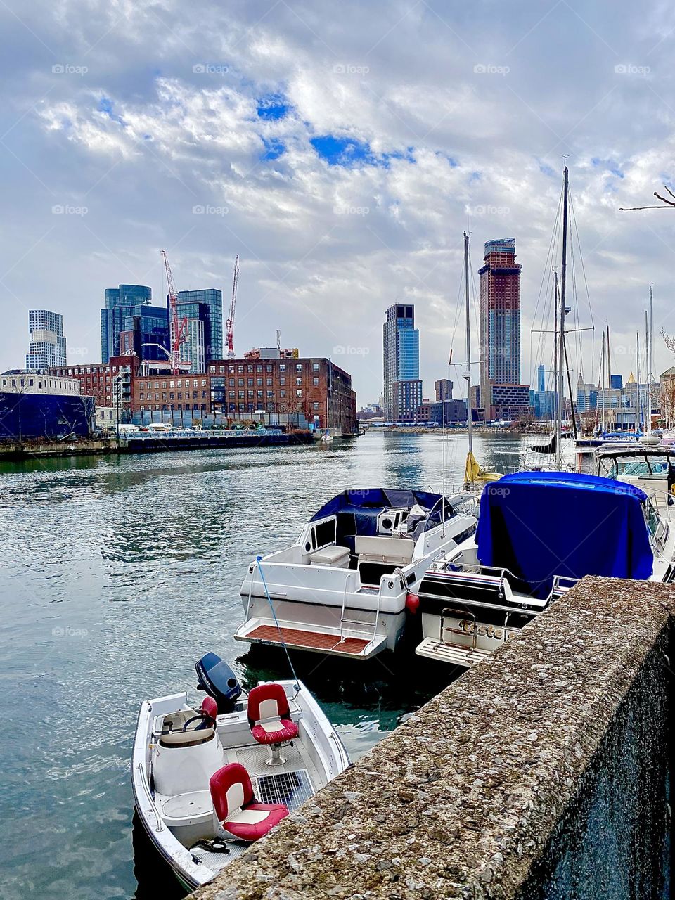 Newtown Creek in Long Island City, Queens, NY as seen from the parking lot underneath the Pulaski Bridge on an overcast day in December 2021 with a faint outline of Manhattan in the far distance. Hypnotic Productions