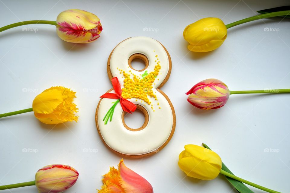 8 March gingerbread and colorful tulips on a white background women's day