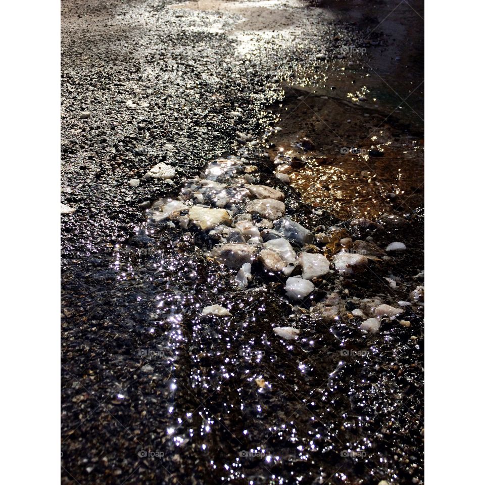 Water rocks, asphalt gravel road wet 