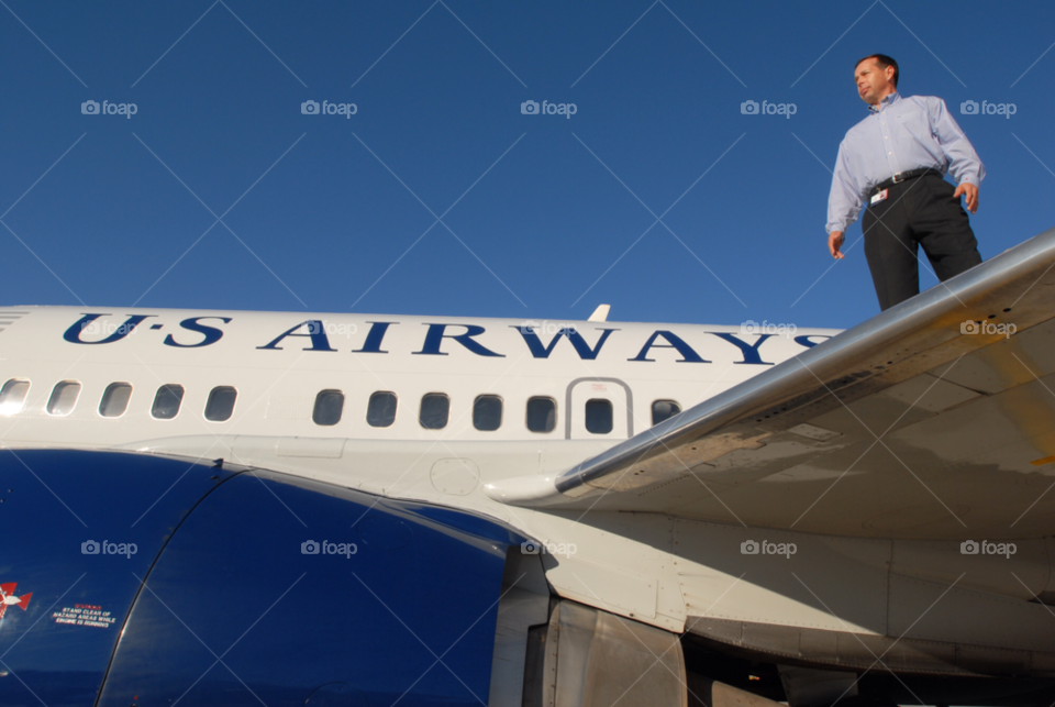us airways cfo on wing of one of their jetliners. wing walker. by arizphotog