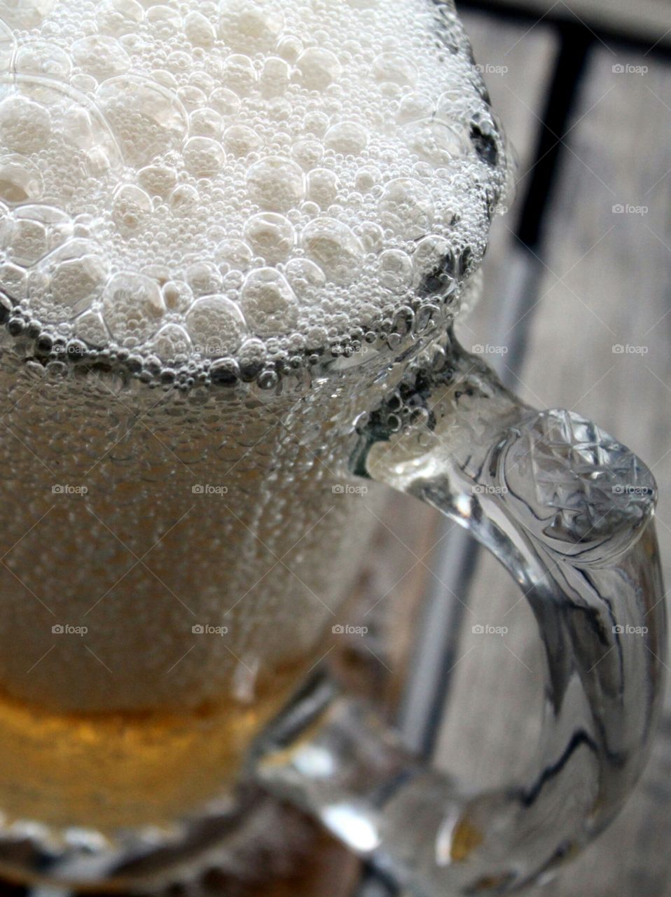 Beer glass with overflowing foam