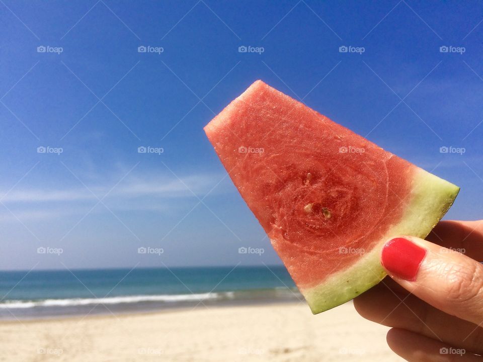 Watermelon and beautiful day on sunny beach 
