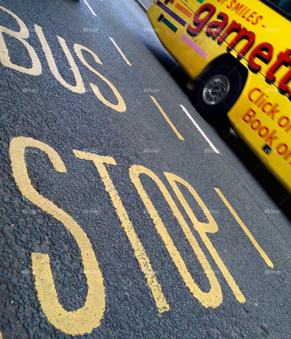 Writing On The Road. Bus stop markings on the road ...