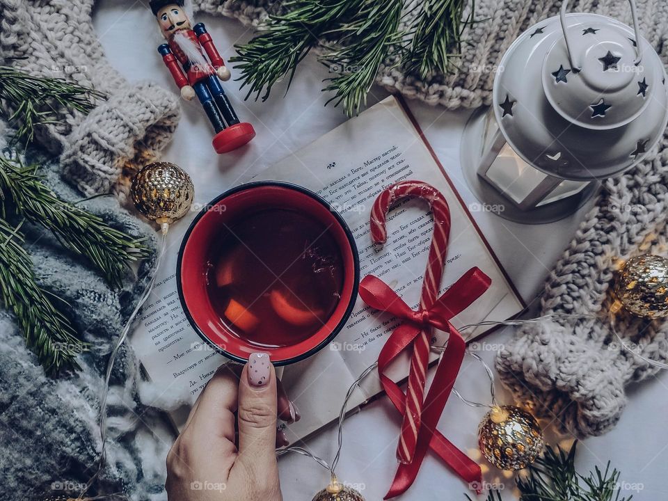 Flatlay with cup of tea, book and candy