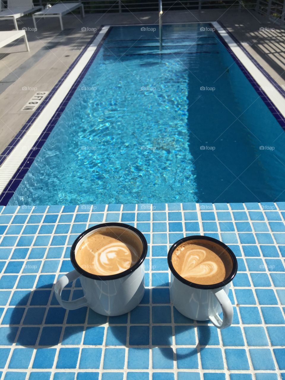 Coffee mug on swimming pool