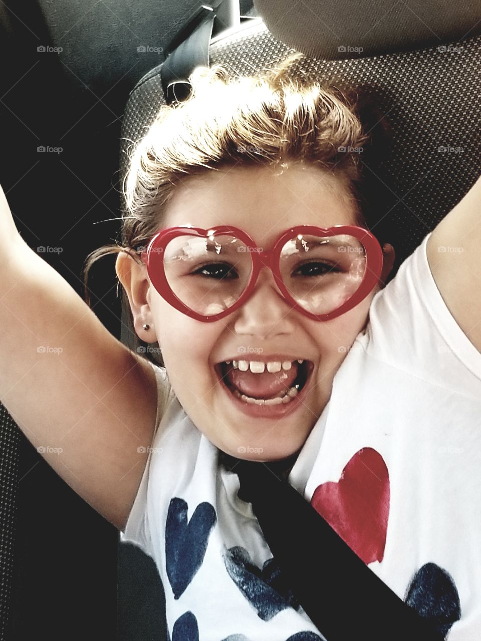 heart shaped glasses.  smiling child. happiness.  youthfulness.