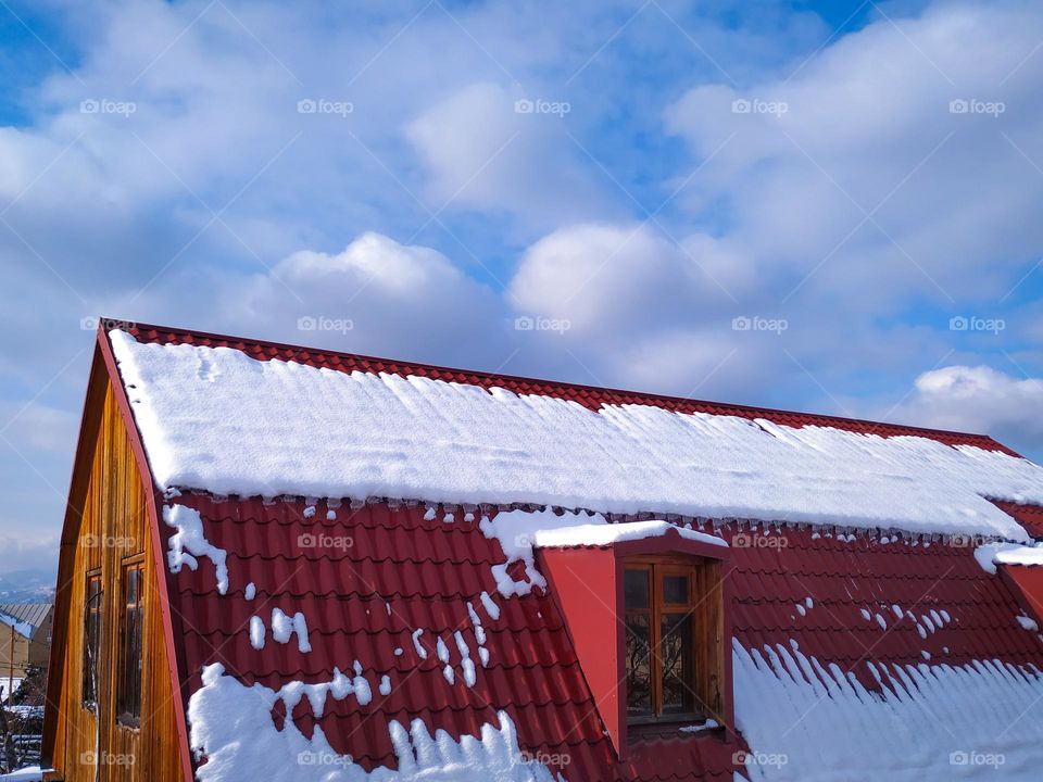 The roof of a snowy house