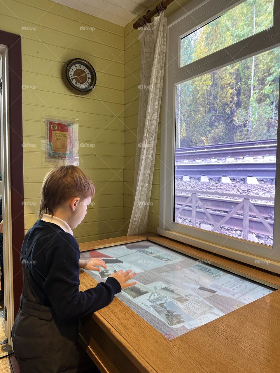Boy stay near the window 