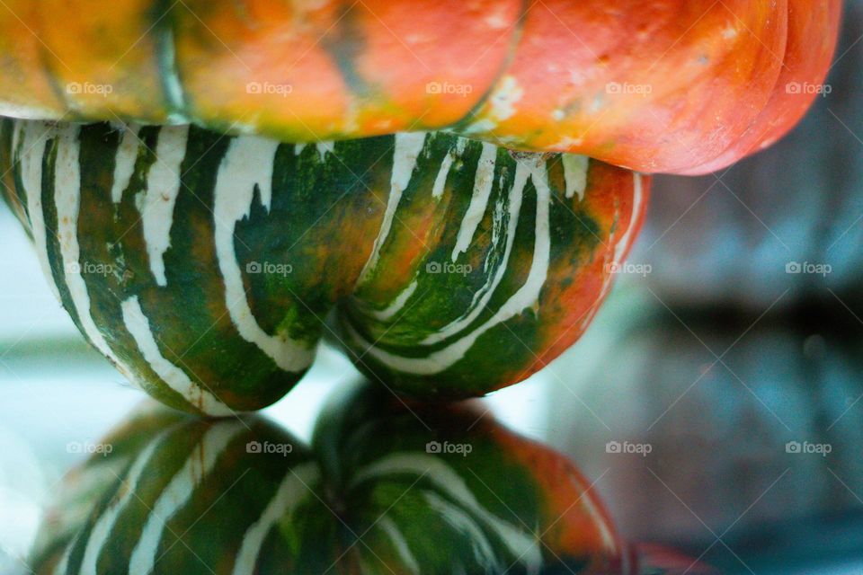 Fall harvest produces these beautiful coloured and fantastic tasting squash and pumpkins for making a myriad of recipes from soup to brownies! The multi-coloured capped squash in front of a blue pumpkin are in full grandiose display on the mirror. 🧡