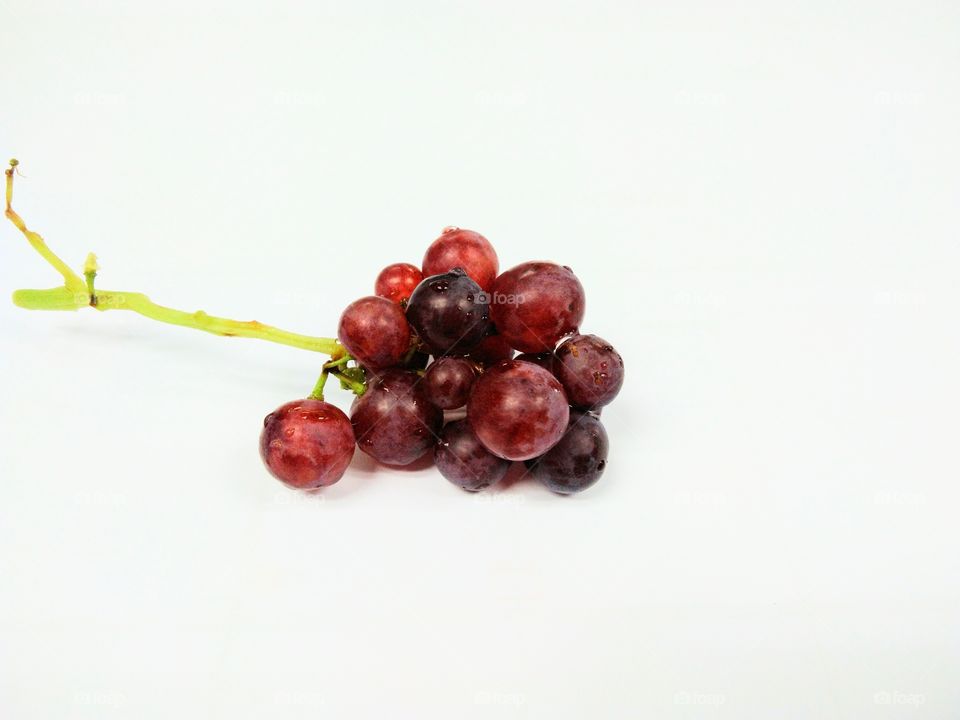 Seedless grapefruit isolated on white background.Water drop on fresh purple grape.