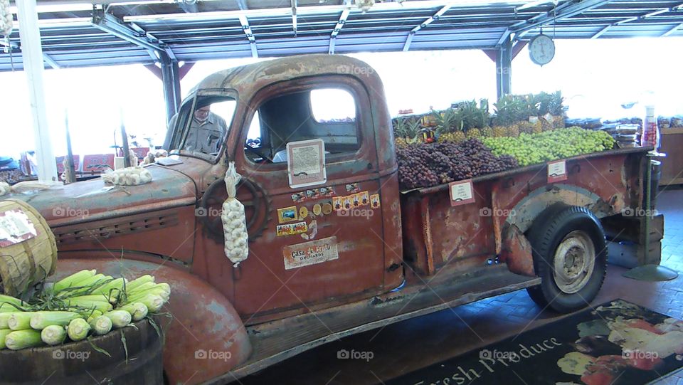 an old truck filled with lots of fruits