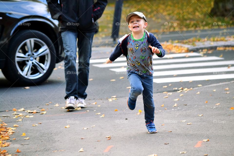 Happy boy running to meet his mother