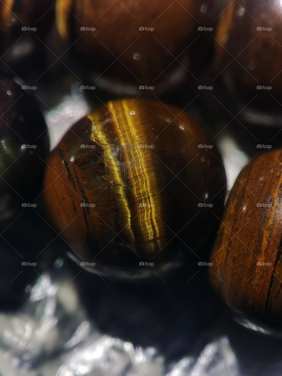 Macro photo of natural tiger eye stone lying on the table