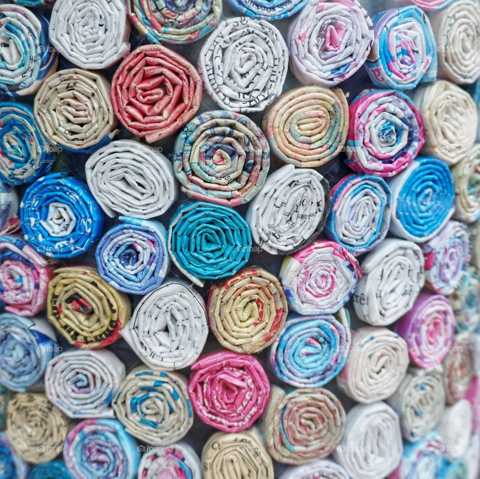 This is a close up shot of a vase through a shop window ... it was decorated in tiny scrolls of rolled up paper from magazines .. really effective ... caught my eye ๐